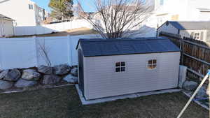 View of outbuilding featuring a lawn