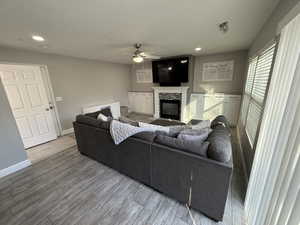 Living room with hardwood / wood-style flooring and ceiling fan