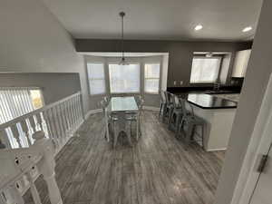 Dining space featuring sink, wood-type flooring, and a textured ceiling