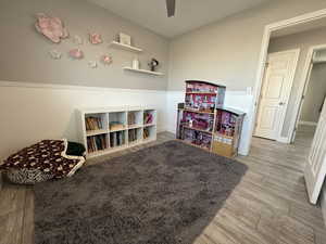 Playroom featuring wood-type flooring and ceiling fan