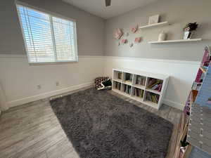 Recreation room with hardwood / wood-style floors and ceiling fan