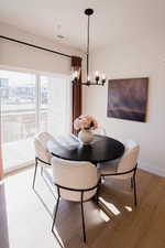 Dining space featuring wood-type flooring and a notable chandelier