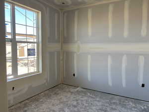 Unfurnished room featuring plenty of natural light