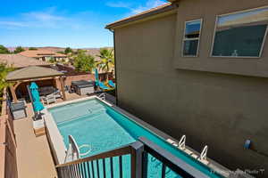 View of swimming pool with a gazebo, a jacuzzi, and a patio area