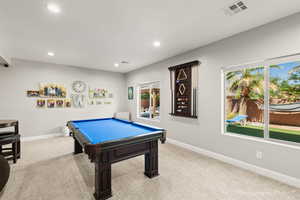 Recreation room with light carpet and billiards