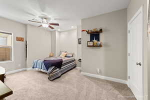 Bedroom with ceiling fan and carpet