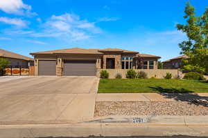 Prairie-style home featuring a garage and a front yard