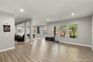 Workout room with light hardwood / wood-style flooring