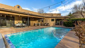 View of pool featuring a patio area and ceiling fan