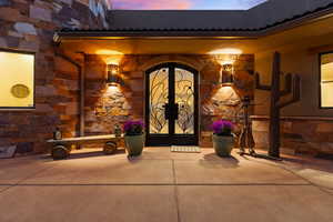 Exterior entry at dusk featuring french doors