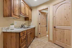 Kitchen with sink and light tile patterned floors