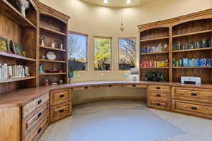 Office featuring built in desk and recessed lighting