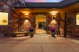 Exterior entry at dusk with a patio