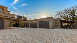 Property exterior at dusk featuring a carport and a garage