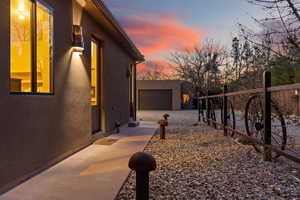 Property exterior at dusk with an outbuilding and a garage