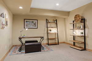 Living area with carpet, baseboards, and recessed lighting