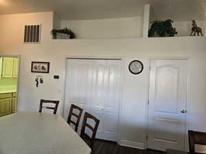 Dining space featuring dark hardwood / wood-style flooring and a textured ceiling