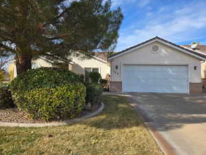 View of front of property with a garage and a front yard