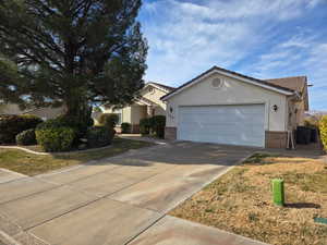 Single story home featuring a garage and a front yard