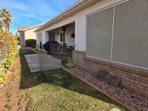 View of side of home with a lawn and a patio area