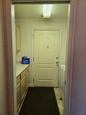 Doorway featuring washing machine and dryer and a textured ceiling