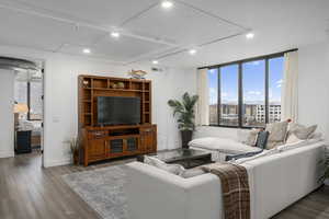 Living room with LVP flooring and raised ceiling height