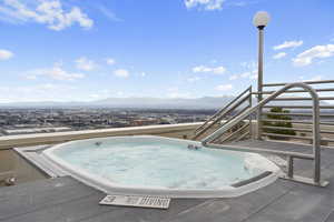 View of pool featuring a mountain view and a hot tub