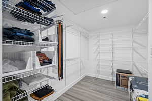 Primary Spacious closet with LVP flooring