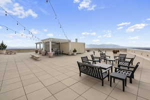 View of patio / terrace with a mountain view, a pergola, and an outdoor fire pit