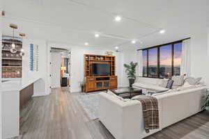 Living room featuring track lighting and LVP flooring