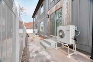 View of patio with a mountain view and ac unit