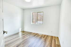 Unfurnished room with light wood-type flooring