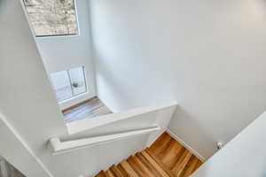 Stairs featuring hardwood / wood-style floors