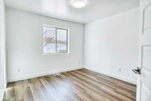 Empty room with light wood-type flooring