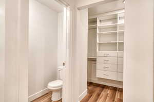 Bathroom featuring hardwood / wood-style flooring and toilet