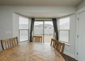 Dining space with dark wood-type flooring