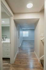 Hall featuring hardwood / wood-style floors and sink