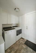 Laundry room with cabinets and separate washer and dryer