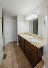 Bathroom featuring tile patterned flooring and vanity