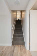 Staircase featuring hardwood / wood-style floors