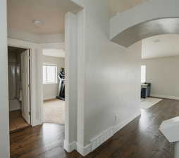 Corridor featuring dark wood-type flooring