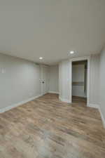 Basement featuring light hardwood / wood-style floors and a textured ceiling