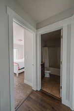 Hallway with dark hardwood / wood-style flooring