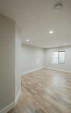 Spare room featuring a textured ceiling and light wood-type flooring