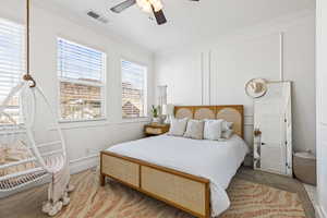 Bedroom with a textured ceiling, ornamental molding, and ceiling fan