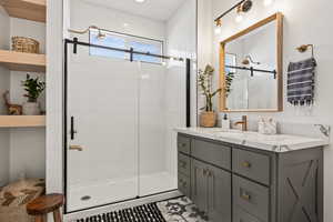 Bathroom with an enclosed shower and vanity