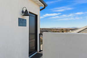 Property entrance featuring a mountain view and a balcony