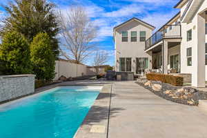 View of pool with a patio, grilling area, and a jacuzzi