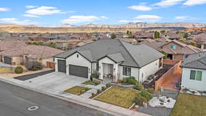 View of front of house with a garage, a mountain view, cooling unit, and a front lawn