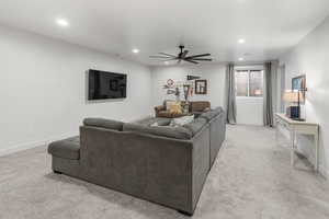 Living room with light colored carpet and ceiling fan